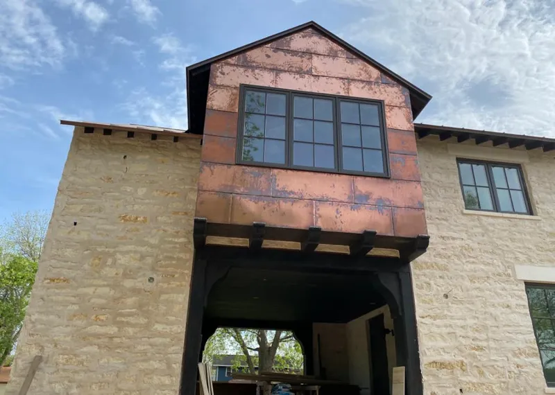 Copper metal panel facade on a stone building for Metal Roof Coating in Madras